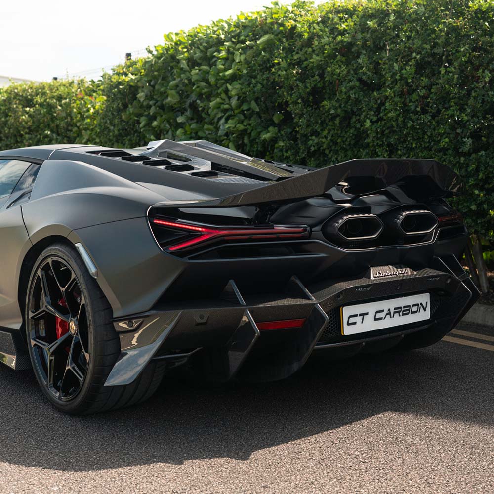 Lamborghini Revueltto full carbon fiber kit by CT Carbon, showing detailed carbon fiber panels on a sleek sports car.