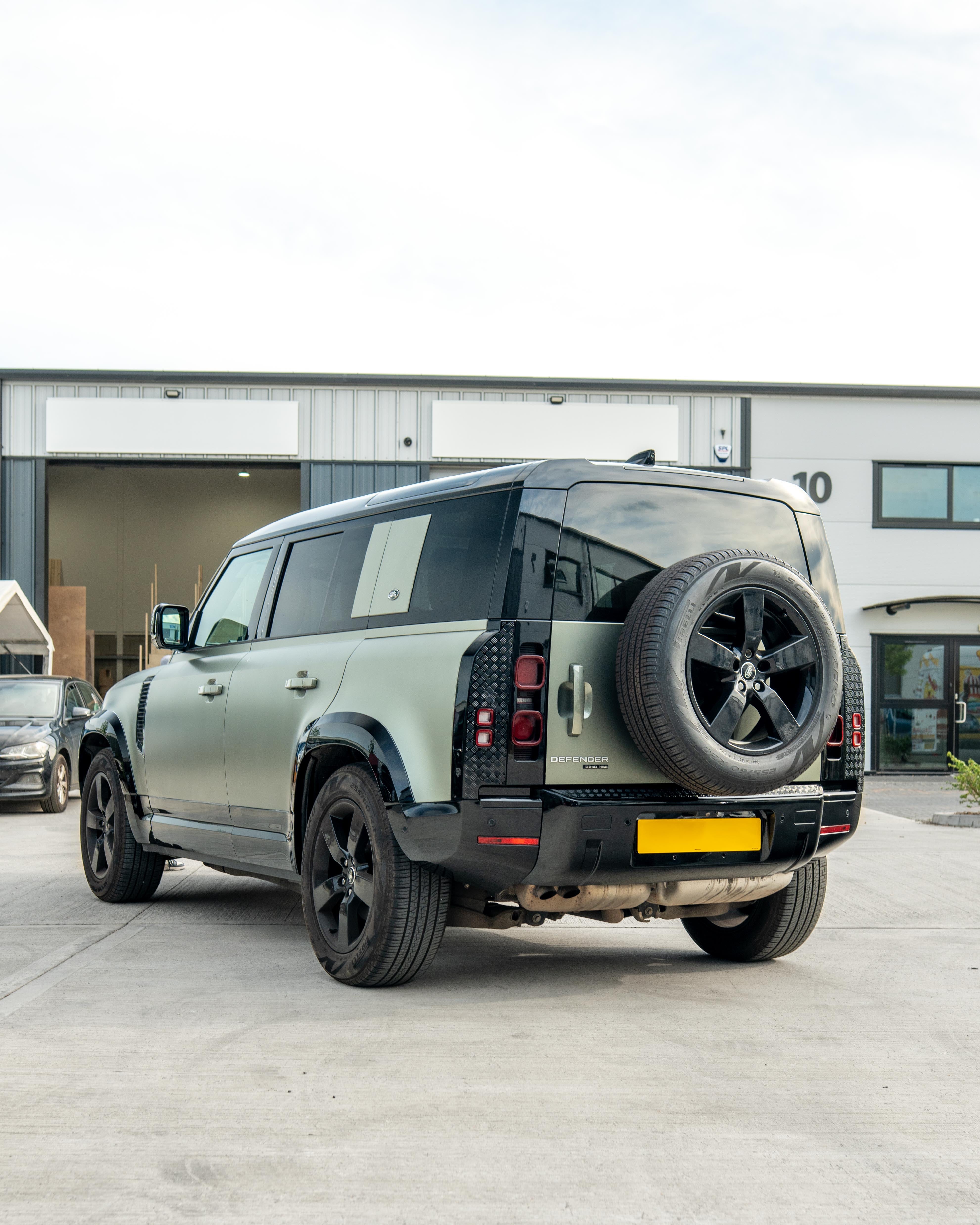 Gloss black door panels for Land Rover Defender L663 110 by CT Carbon, anti-scratch trim set for enhanced vehicle interior.