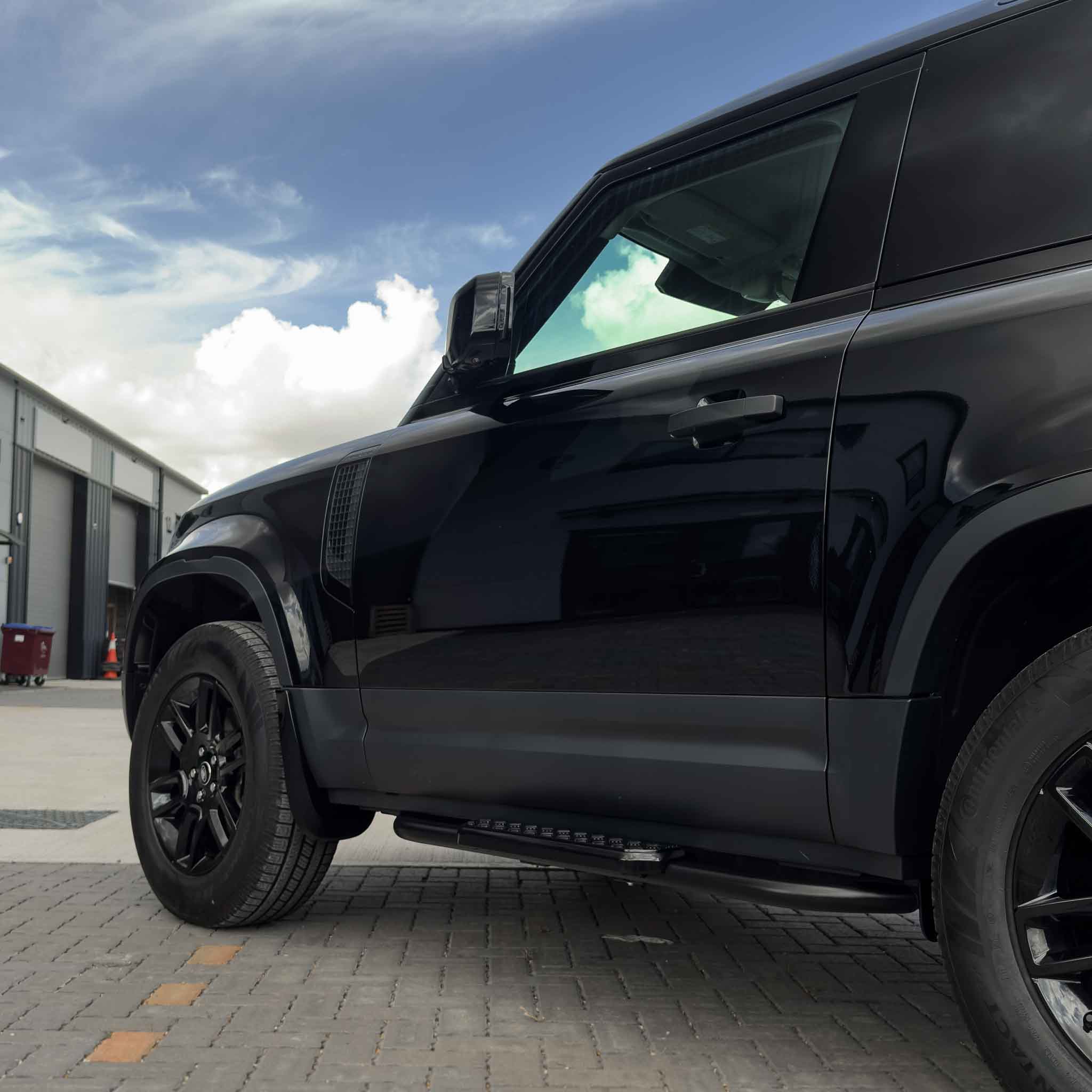 CT Carbon side steps for Land Rover Defender L663 90, mounted on the vehicle's side for easy access and enhanced appearance.