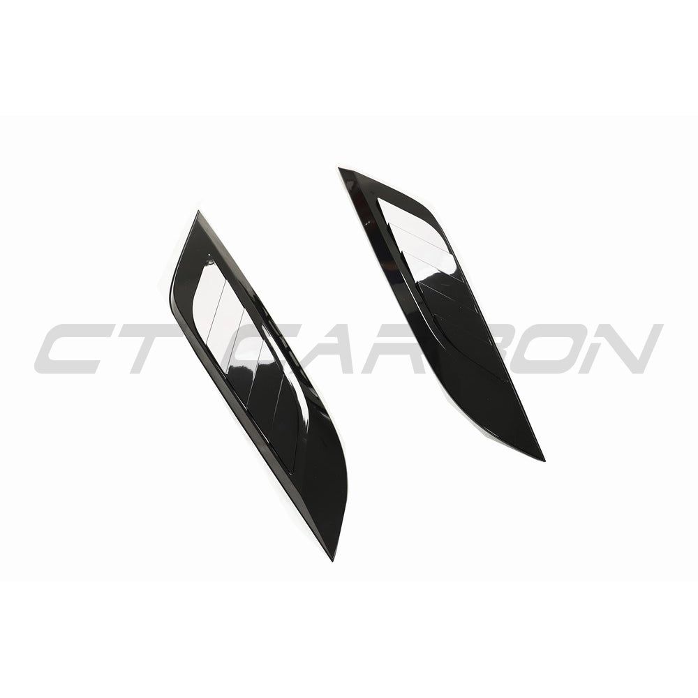 Gloss black Land Rover Defender L663 hood trim accessory by CT Carbon, shown on the vehicle's front hood area.