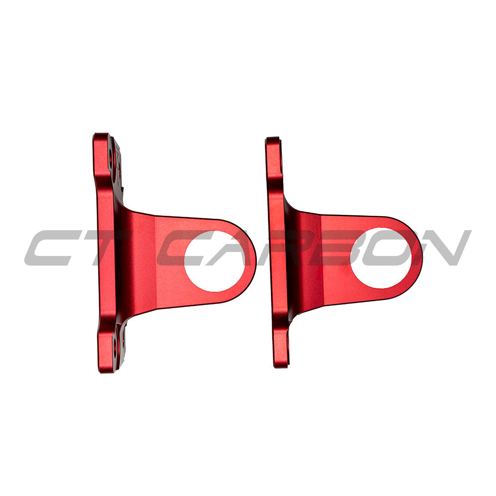 Red aluminum tow hooks for Land Rover Defender L663 90/110/130, made by CT Carbon, shown on the vehicle's front bumper.