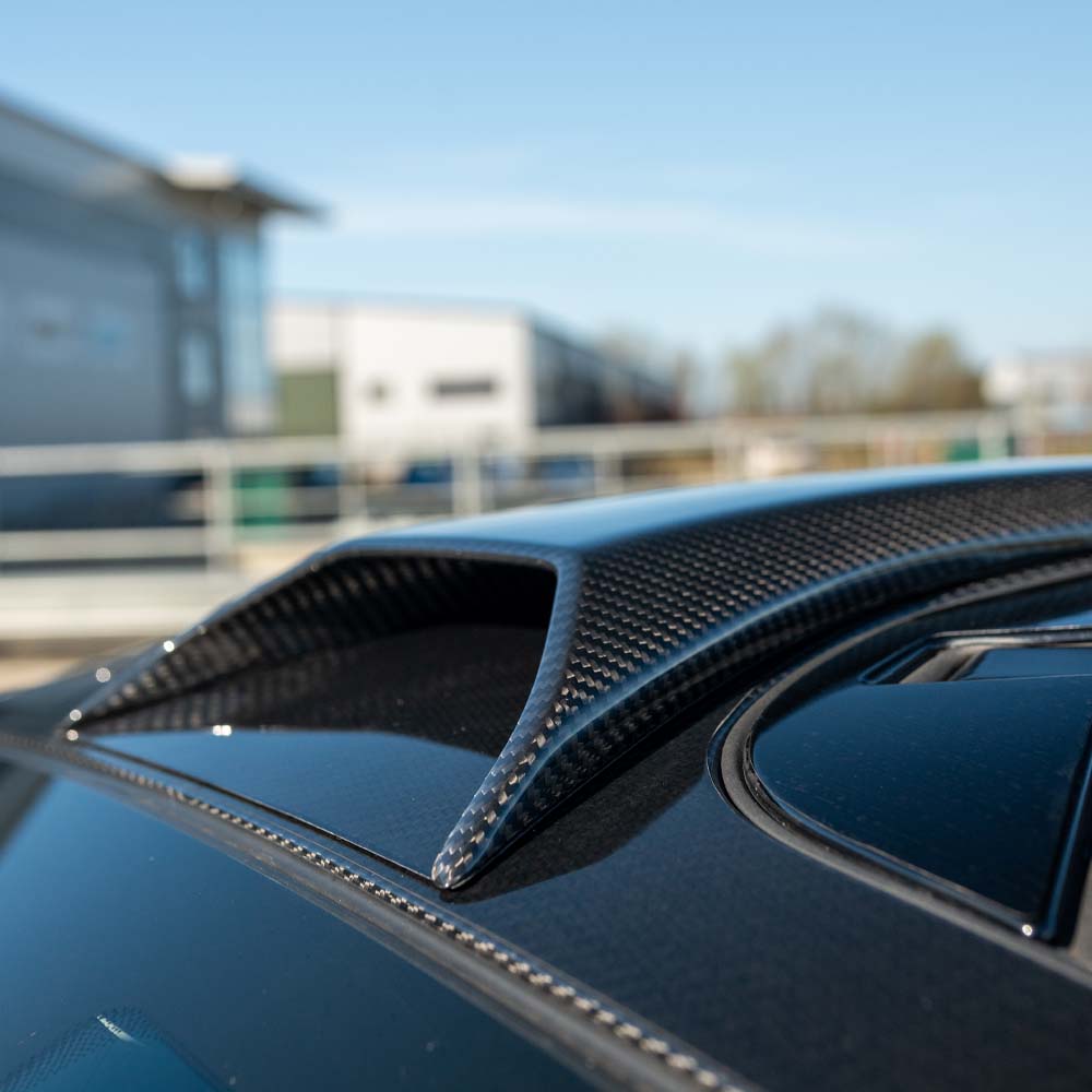 MCLAREN 720S carbon fibre roof scoop by CT Design, featuring aerodynamic design and textured carbon fiber surface.