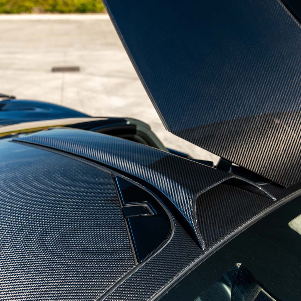 Carbon fiber roof scoop for McLaren 720S by CT Design, showing sleek, aerodynamic design on the car's roof.
