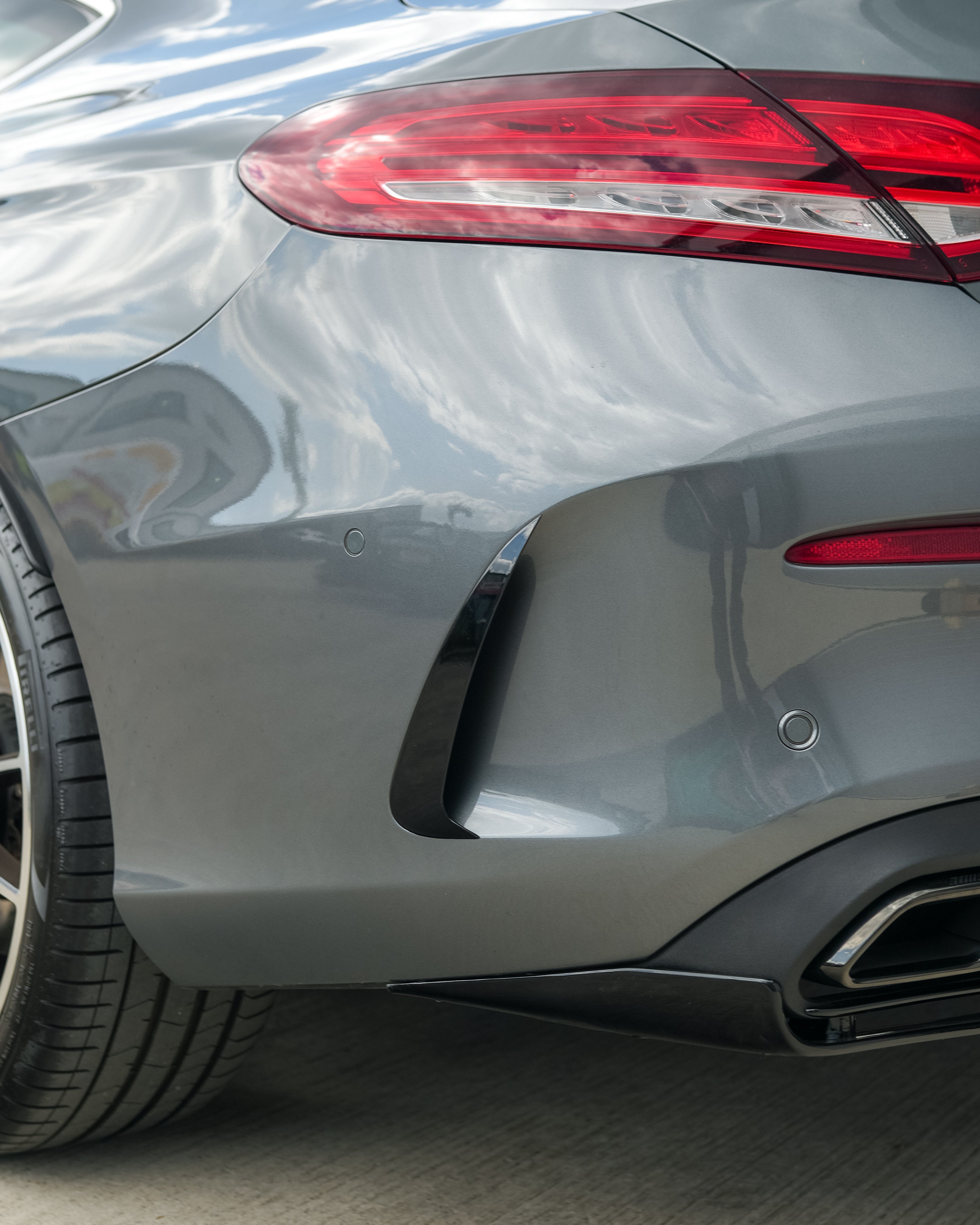Gloss black rear bumper trim for Mercedes C-Class and C43 W205 coupe by CT Carbon, shown on the vehicle.