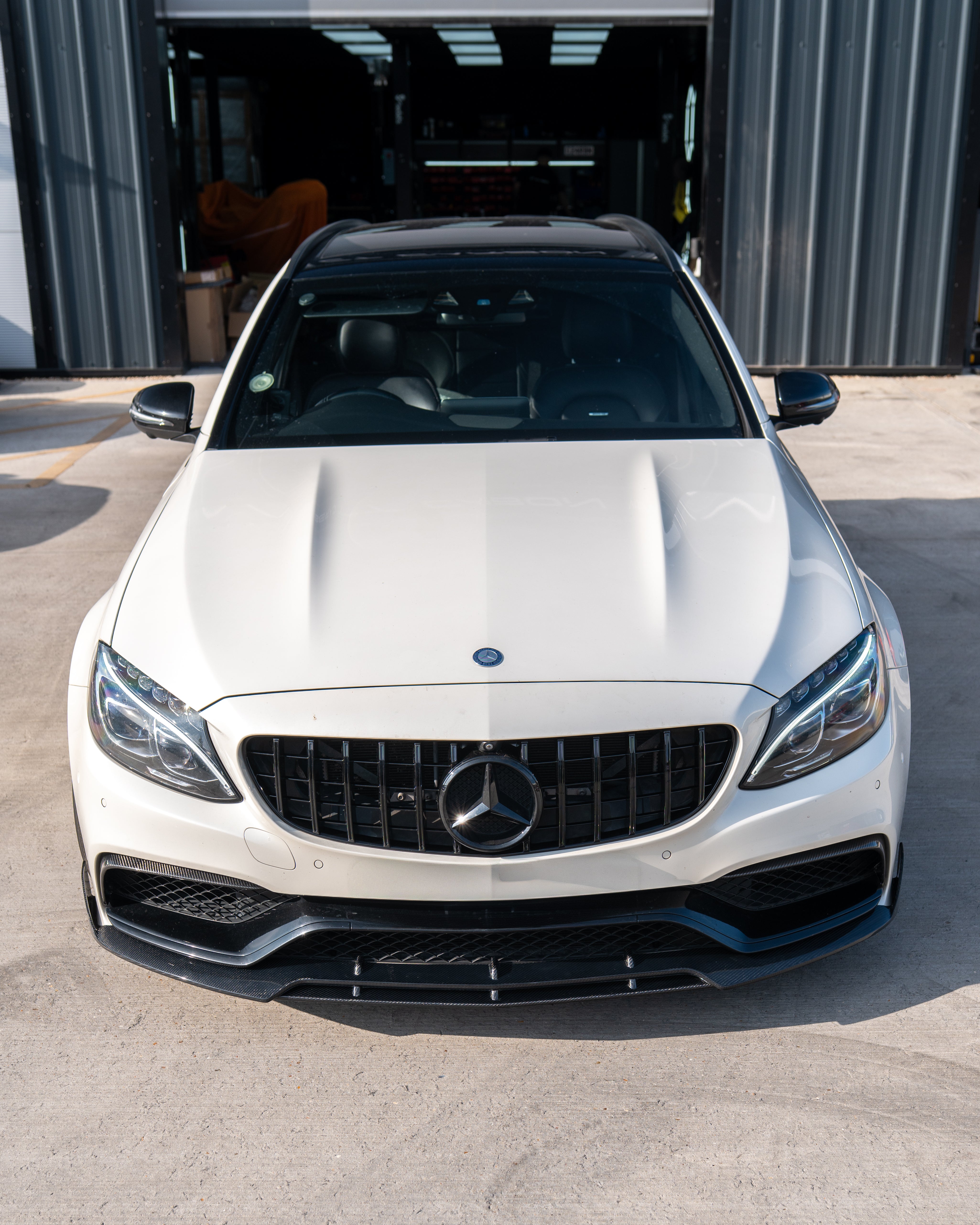 Mercedes C63 W205 saloon and estate car carbon fibre splitter by CT Carbon, featuring sleek V1 style design.
