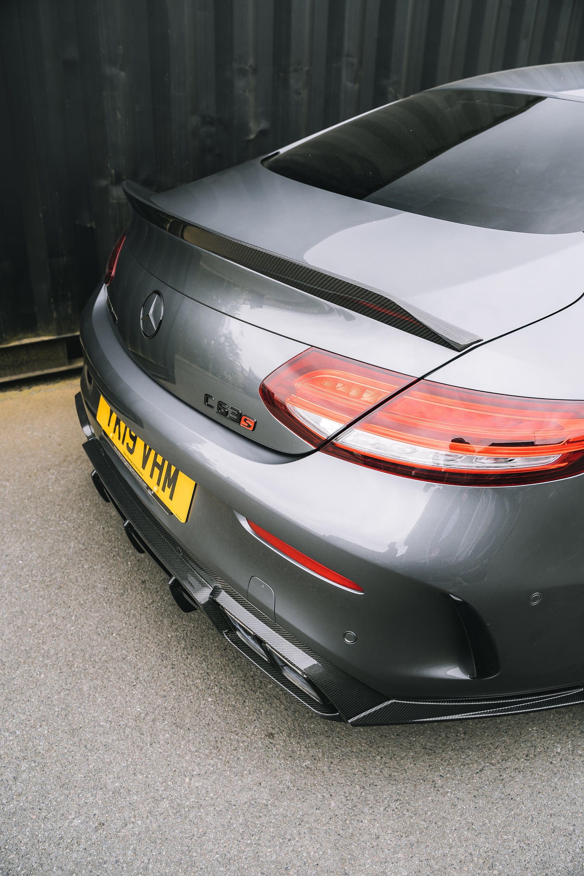 Mercedes C63 C-Class W205 convertible carbon spoiler by CT Carbon, V2 style, showcasing sleek aerodynamic design on the car.
