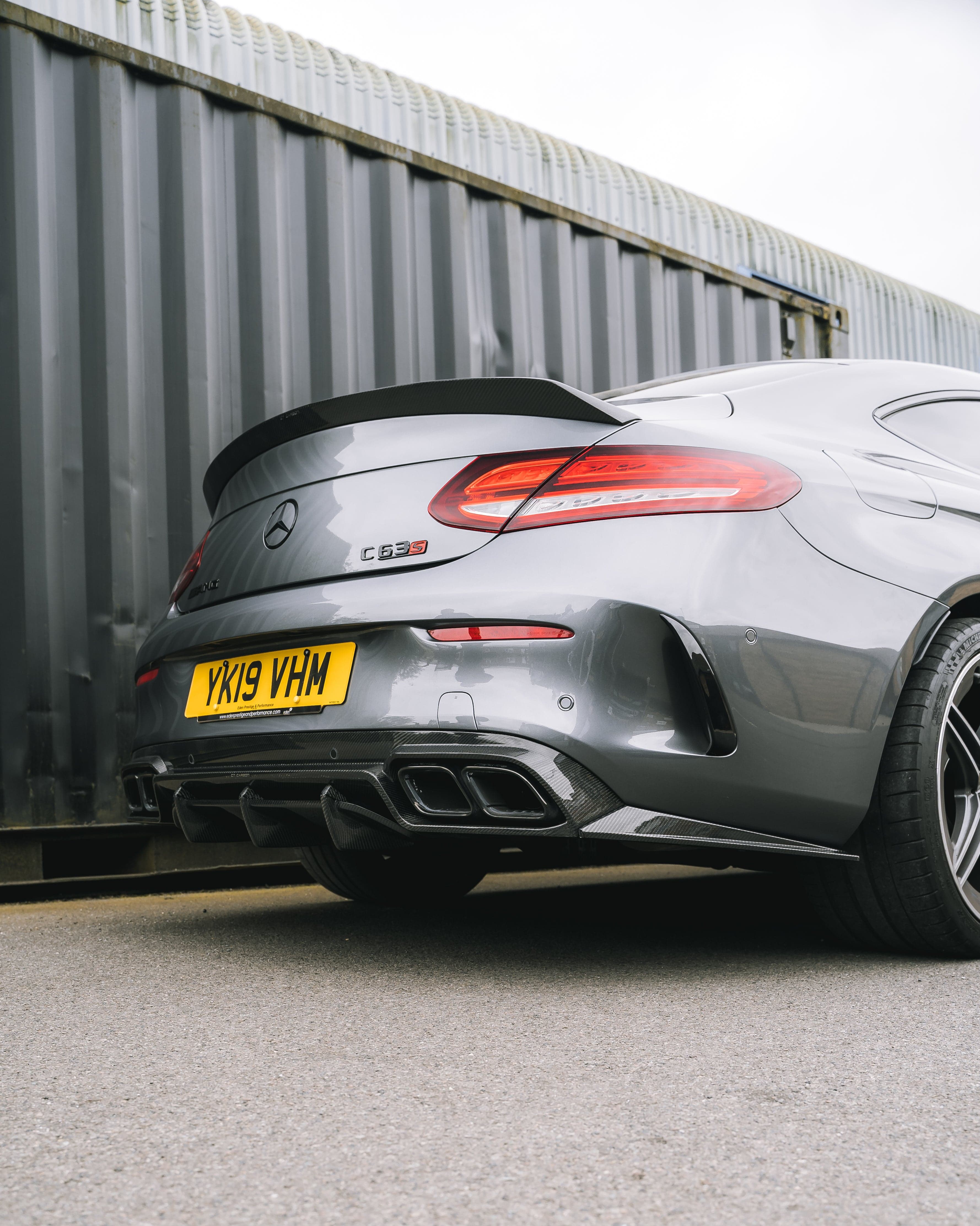 Carbon fiber diffuser for Mercedes W205 C63 facelift coupe and convertible, designed by CT Carbon, showcasing sleek automotive styling.
