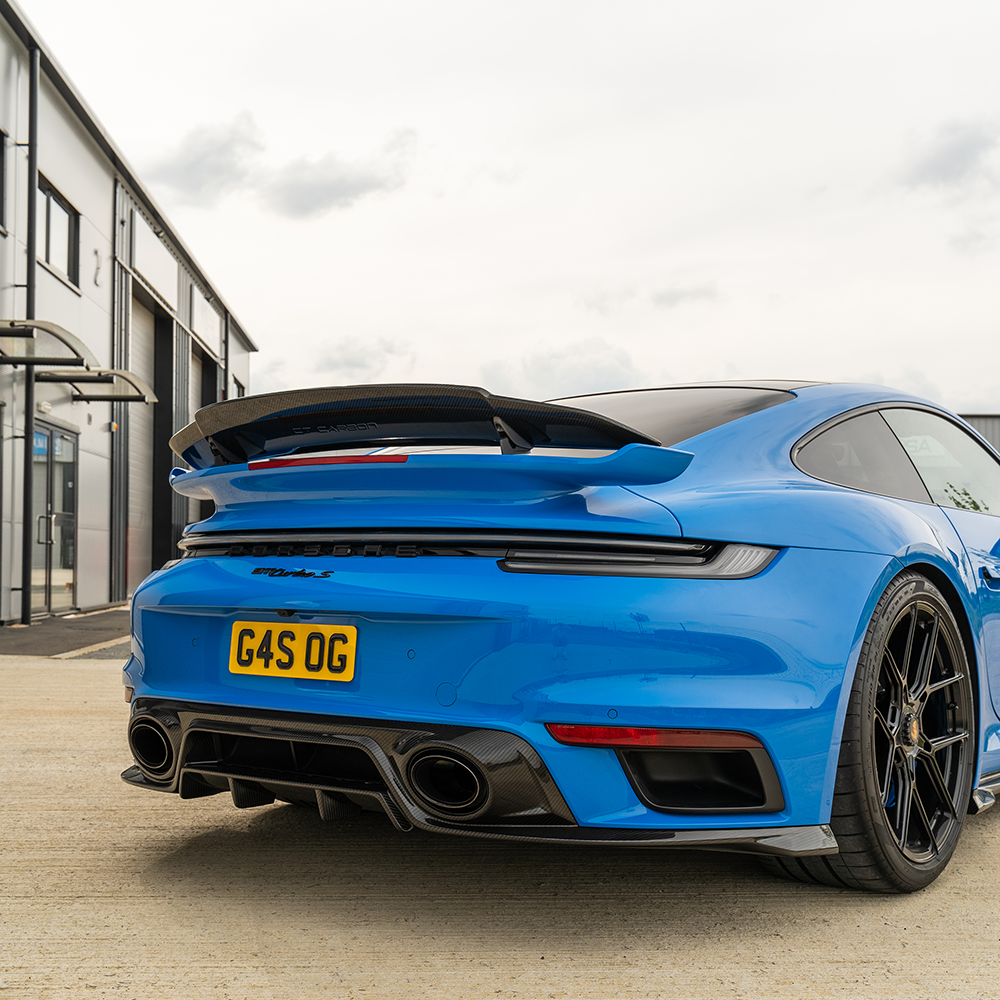 Porsche 911 (992) Turbo S carbon fiber spoiler by CT Design, showcasing sleek aerodynamic design and glossy black finish.