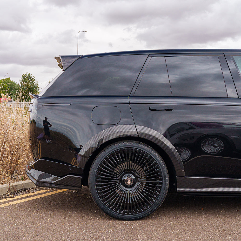Range Rover L460 2022+ carbon fiber diffuser by CT Carbon, showcasing sleek design and textured carbon fiber surface.