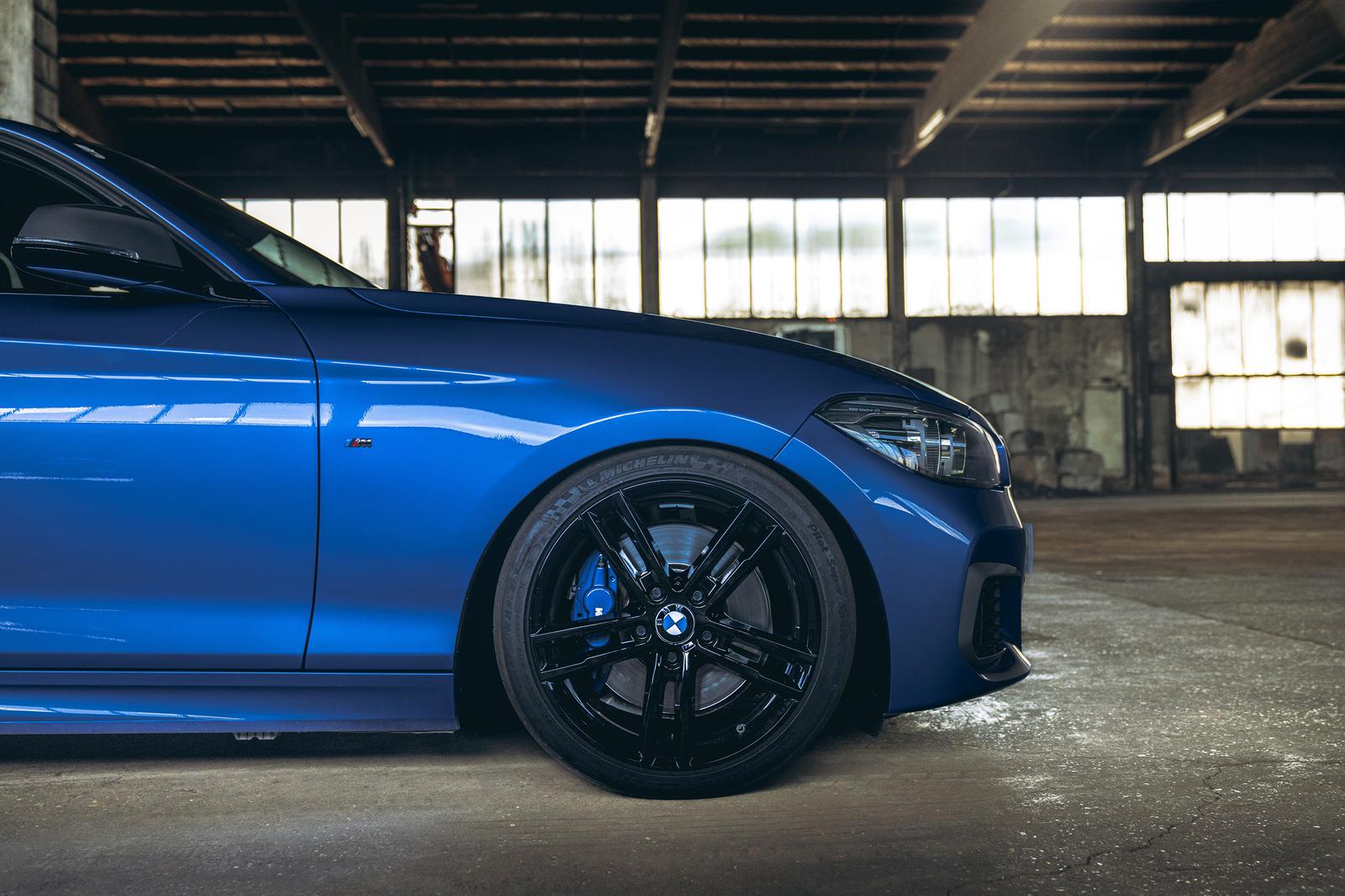 ST Suspension coilovers installed on a BMW F20 M140i showing the adjustable shock absorbers and suspension components.