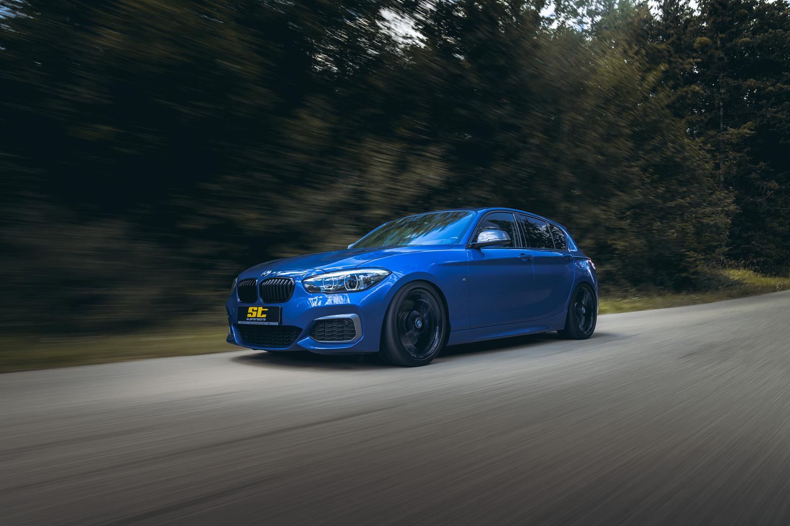 ST Suspension coilovers installed on BMW F20 M140i, showing adjustable shock absorbers and sporty suspension setup.
