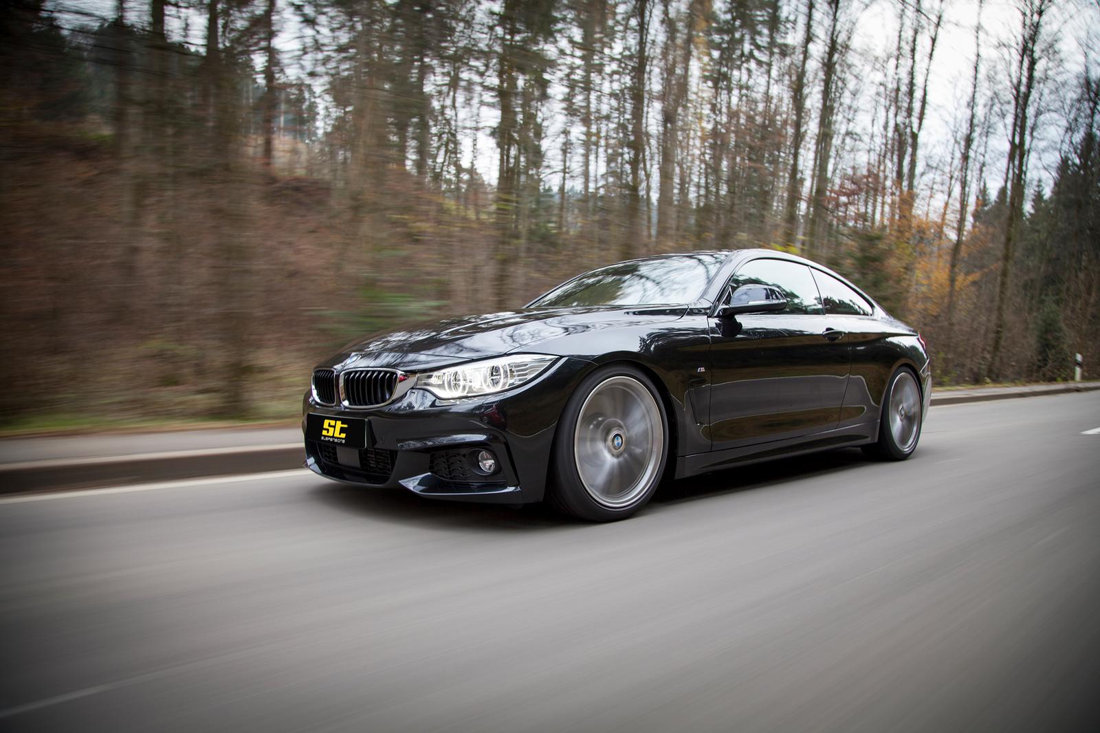 ST Suspension coilovers installed on a BMW F32 4 Series coupe, showing the upgraded suspension setup and performance components.