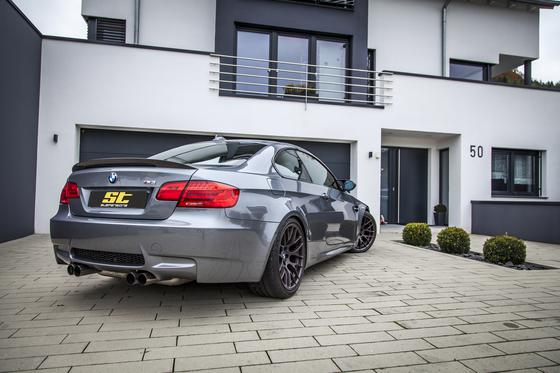 ST Suspension ST XTA Plus coilovers with adjustable damping and top mounts fitted to a BMW E92 M3, showing the suspension components.