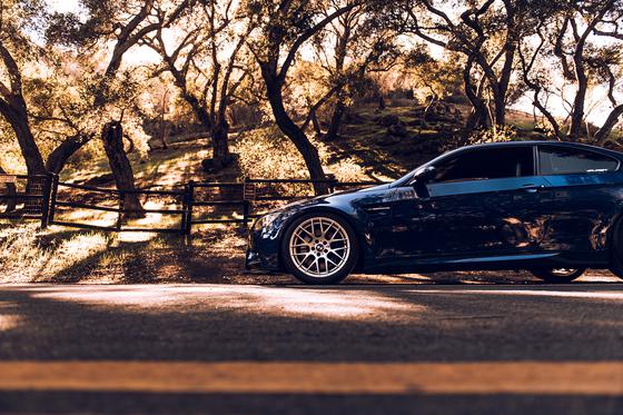 ST Suspension coilovers with adjustable damping and top mounts installed on a BMW E92 M3, showing the performance suspension setup