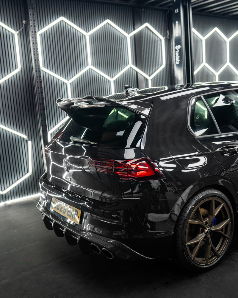 VW Golf MK8 CS carbon fibre spoiler by CT Carbon, showcasing sleek black finish and aerodynamic design on the car's rear.