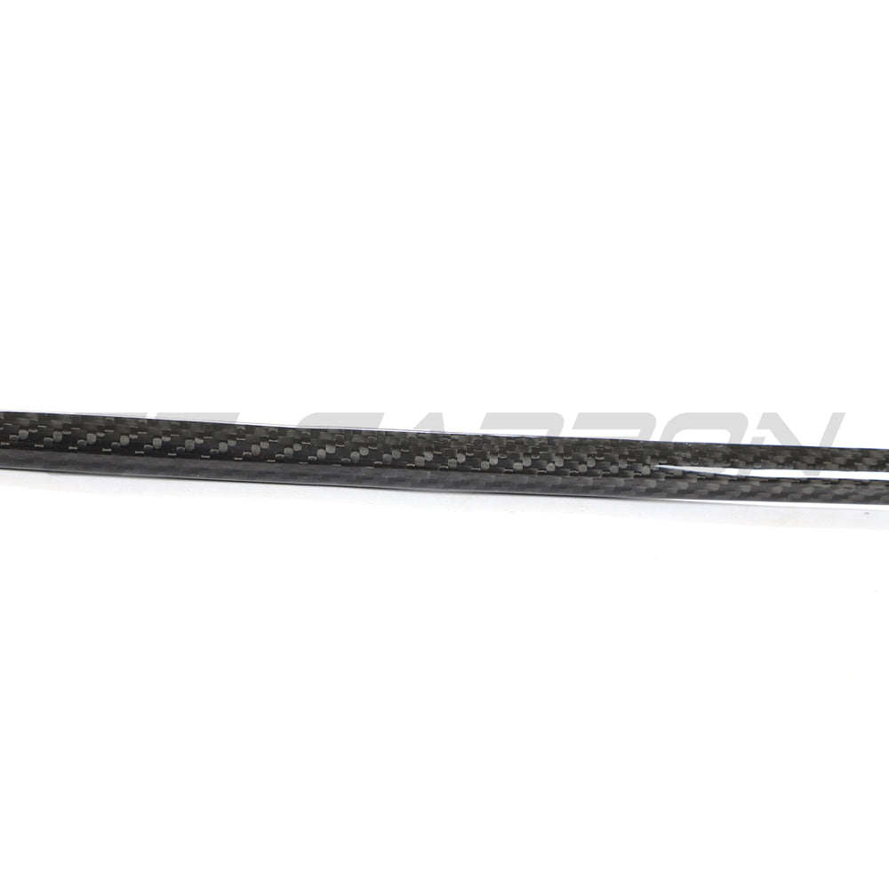 VW Golf MK8 GTI carbon fibre front trim accessory by CT Carbon, showing close-up of sleek, textured carbon fibre material.