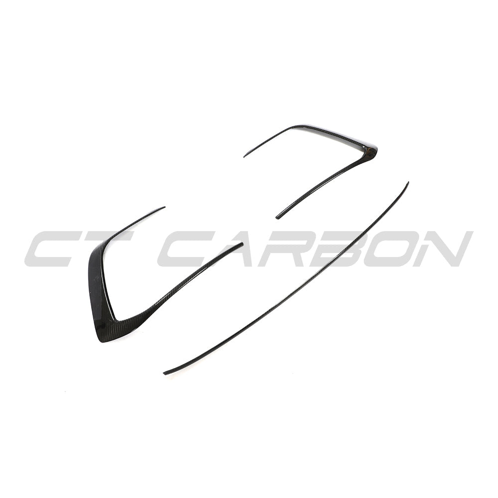 VW Golf MK8 GTI carbon fiber front trim accessory by CT Carbon, showcasing sleek, textured carbon fiber detail on the car's front area.