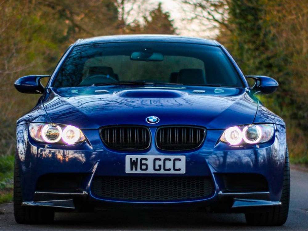 BMW E92 E93 3 Series LCI double slat black grille by CT Carbon, shown in close-up on a black car, highlighting sleek design.