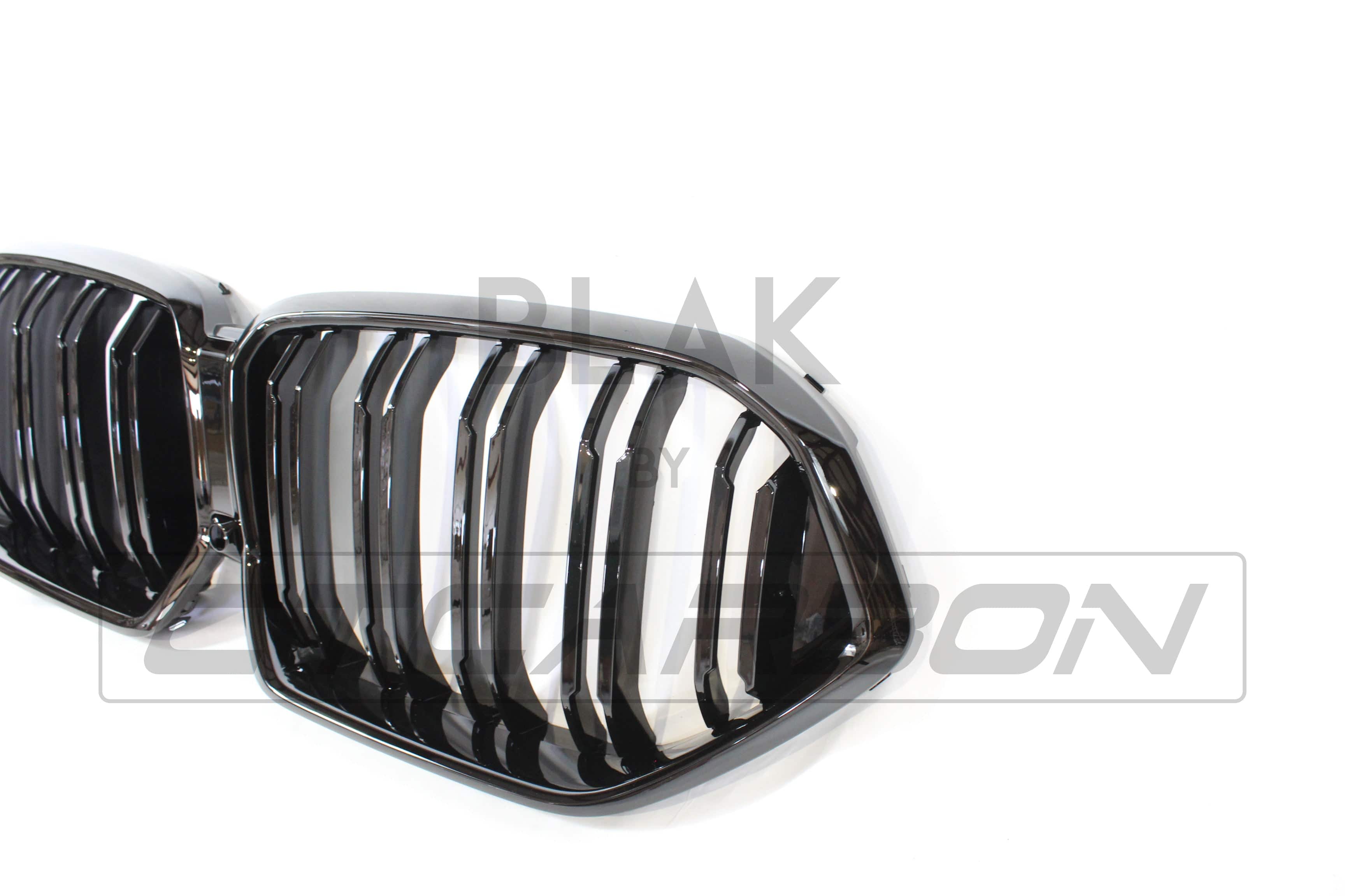 Black BMW G06 X6 2019-2023 double slat grille by CT Carbon, close-up view of sleek black grille design on vehicle front.