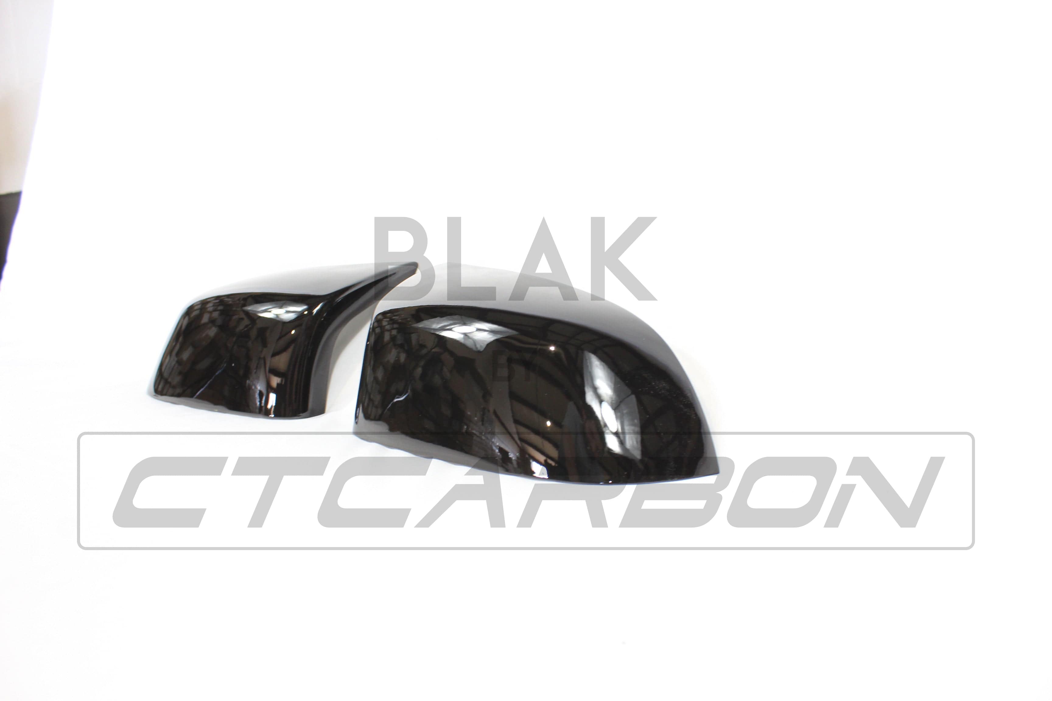 Gloss black mirror replacements for BMW F15/F16 X5/X6 by CT Carbon, showcasing sleek, reflective mirror covers on the vehicle.