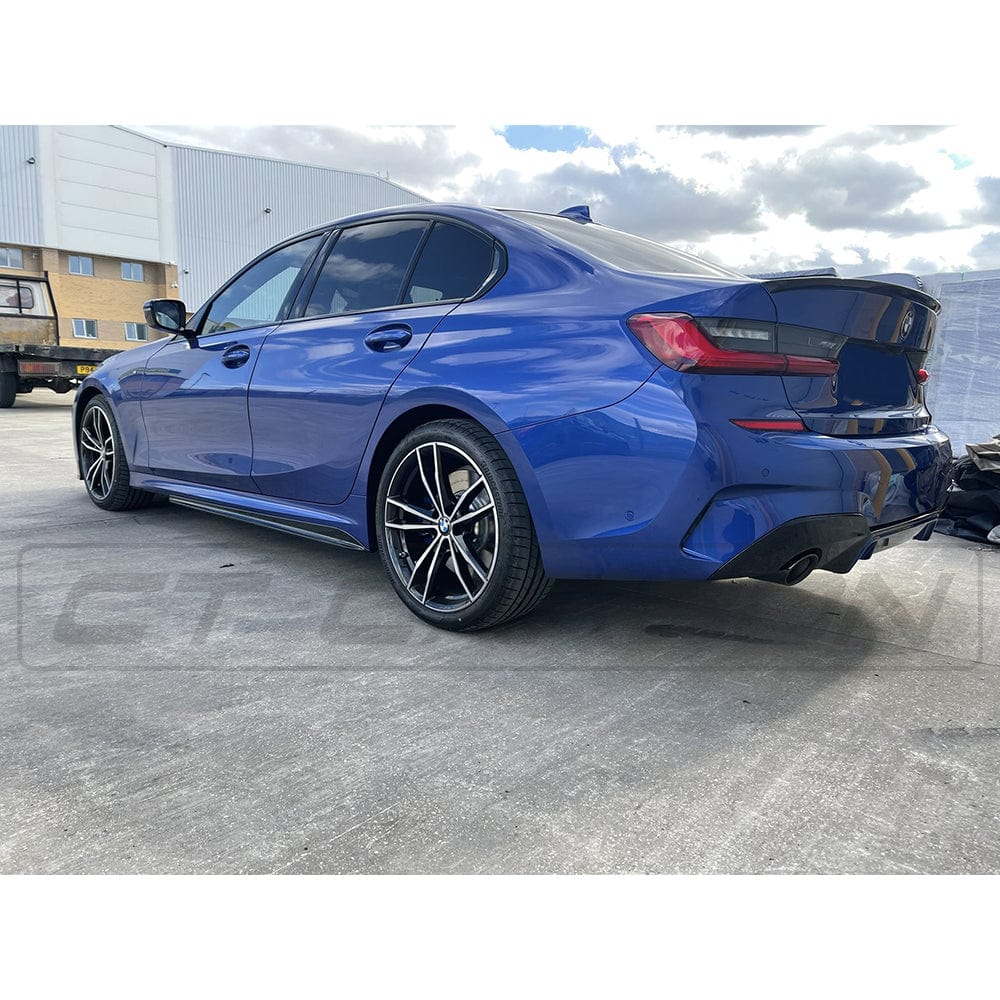 BMW 3 Series G20 G21 gloss black side skirts by CT Carbon, showcasing sleek MP-style side skirts on a black car.
