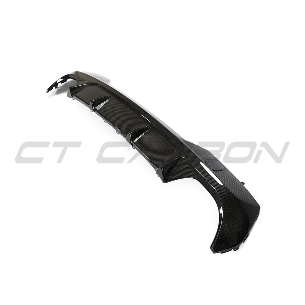 Black BMW G22 4 Series carbon fiber diffuser kit by CT Carbon, showcasing sleek, high-quality carbon fiber material in a close-up shot.