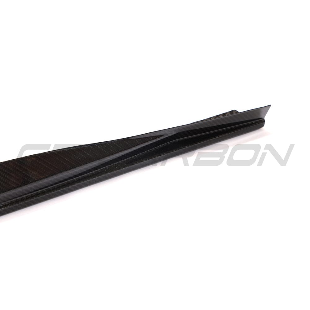 Black BMW G22 4 Series carbon fibre side skirts and diffuser kit by CT Carbon, showcasing sleek, lightweight carbon fibre automotive parts.