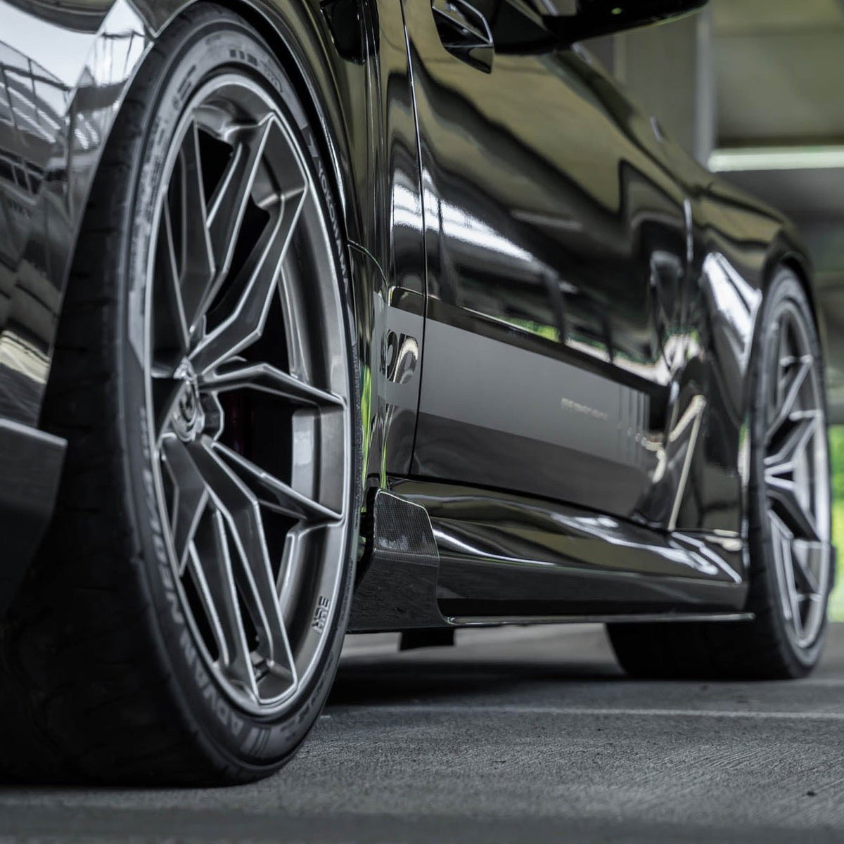 BMW G87 M2 TREVORA TR87 pre-preg carbon fibre side skirts, sleek and lightweight with a textured finish, designed for 2023 models.