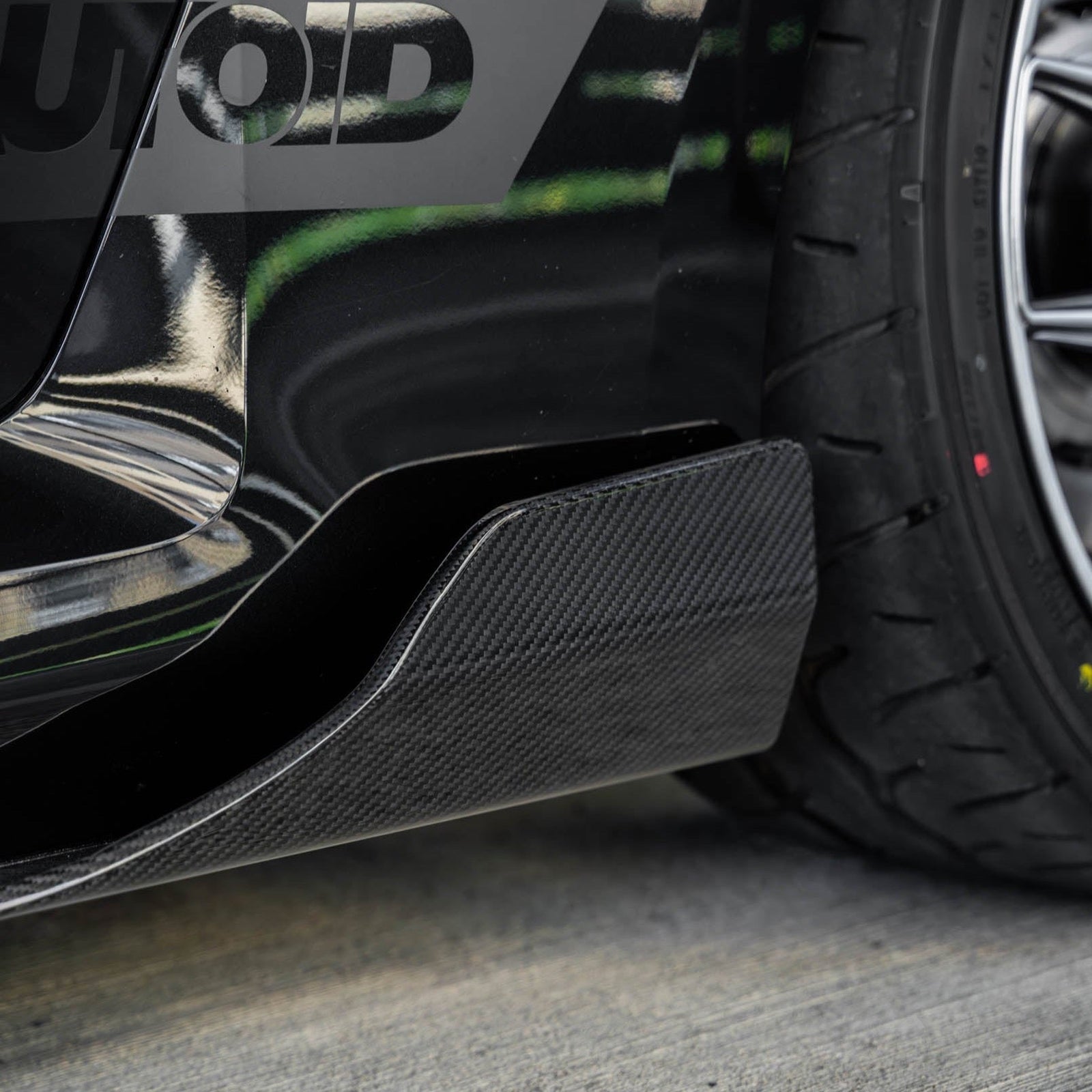 BMW G87 M2 TREVORA TR87 carbon fibre side skirts, lightweight and sleek, shown installed on the 2023 model, highlighting aerodynamic design.