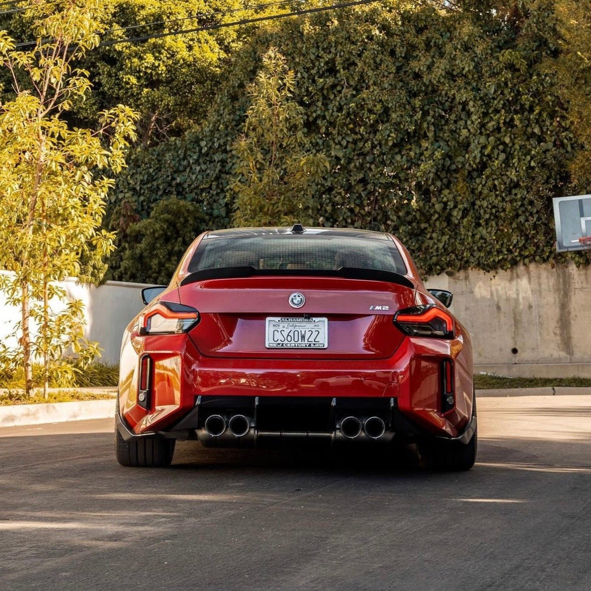BMW G87 M2 TR87 Carbon Body Kit by TREVORA, featuring winged carbon fiber components on a sleek sports car.