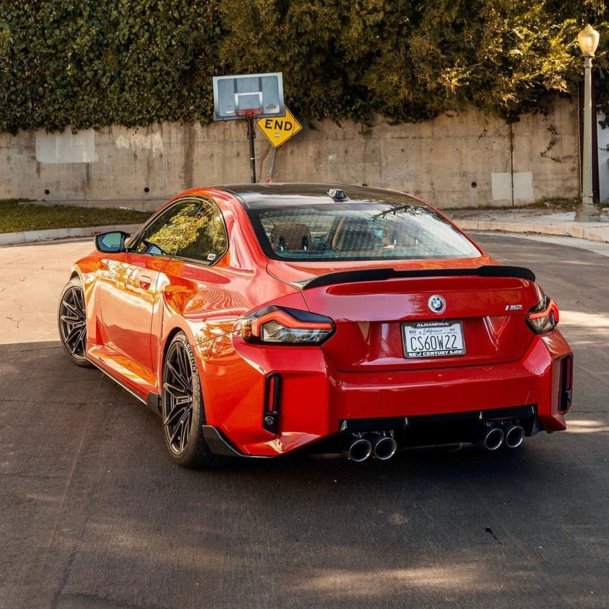 BMW G87 M2 TREVORA TR87 carbon body kit with winged carbon fiber components, showcasing sleek, high-performance automotive design.