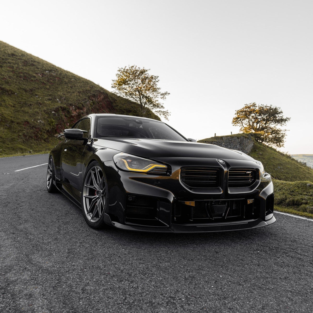 BMW G87 M2 TR87 front splitter with winglets made of pre-preg carbon fiber by TREVORA, 2023 model, shown on vehicle.