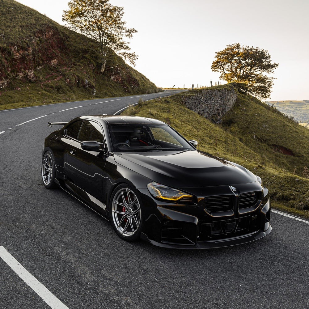 BMW G87 M2 TR87 carbon fibre front splitter with winglets by TREVORA, showcasing aerodynamic design and high-performance materials.