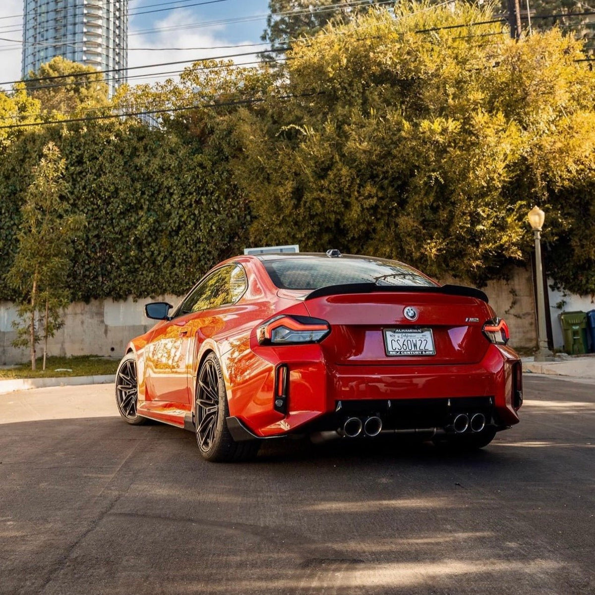 BMW G87 M2 TR87 carbon fibre body kit by TREVORA featuring winged design and sleek finish on a sporty car.