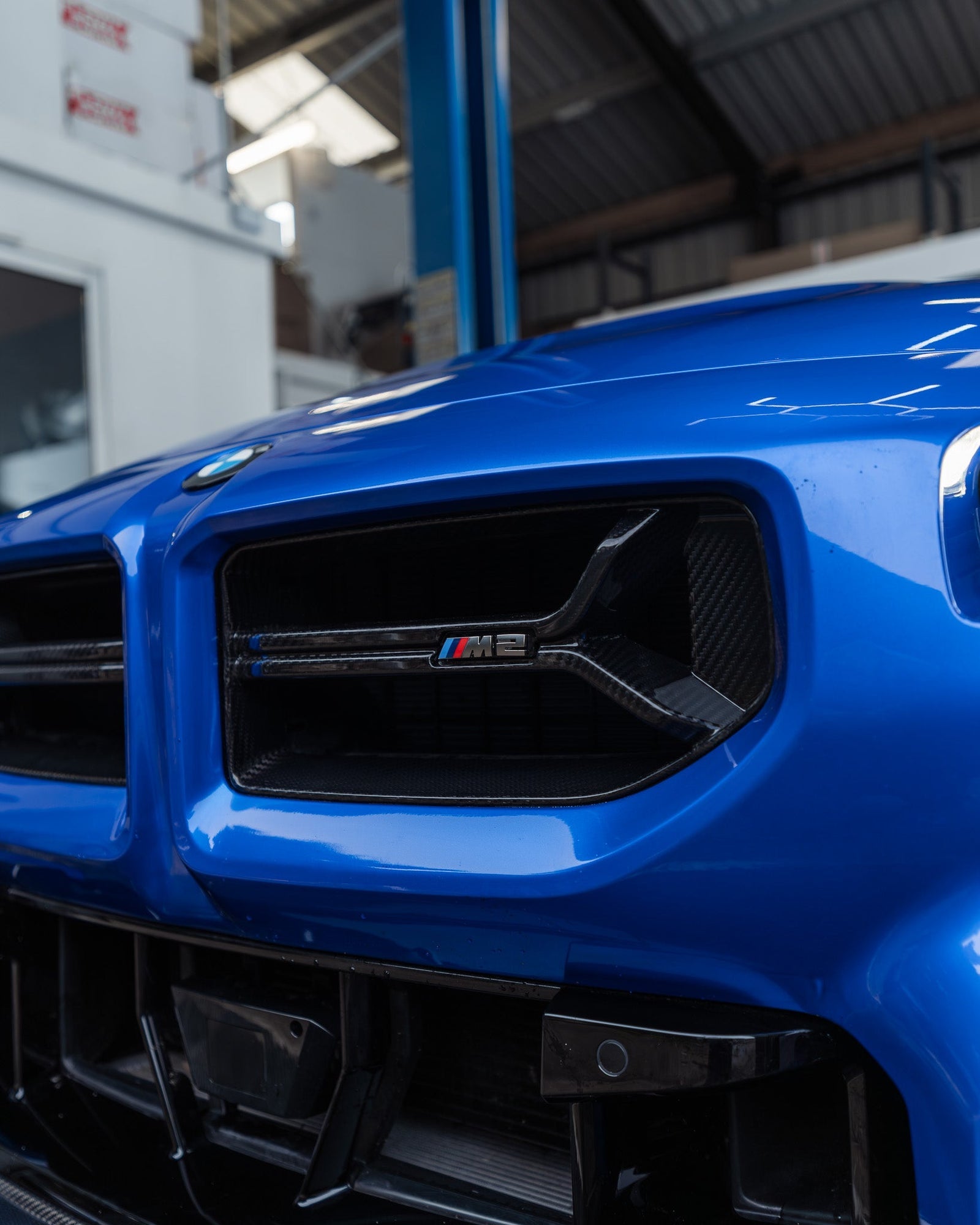 BMW M2 G87 front grille with pre-preg carbon fibre CSL design by TREVORA, showcasing sleek, lightweight automotive styling.