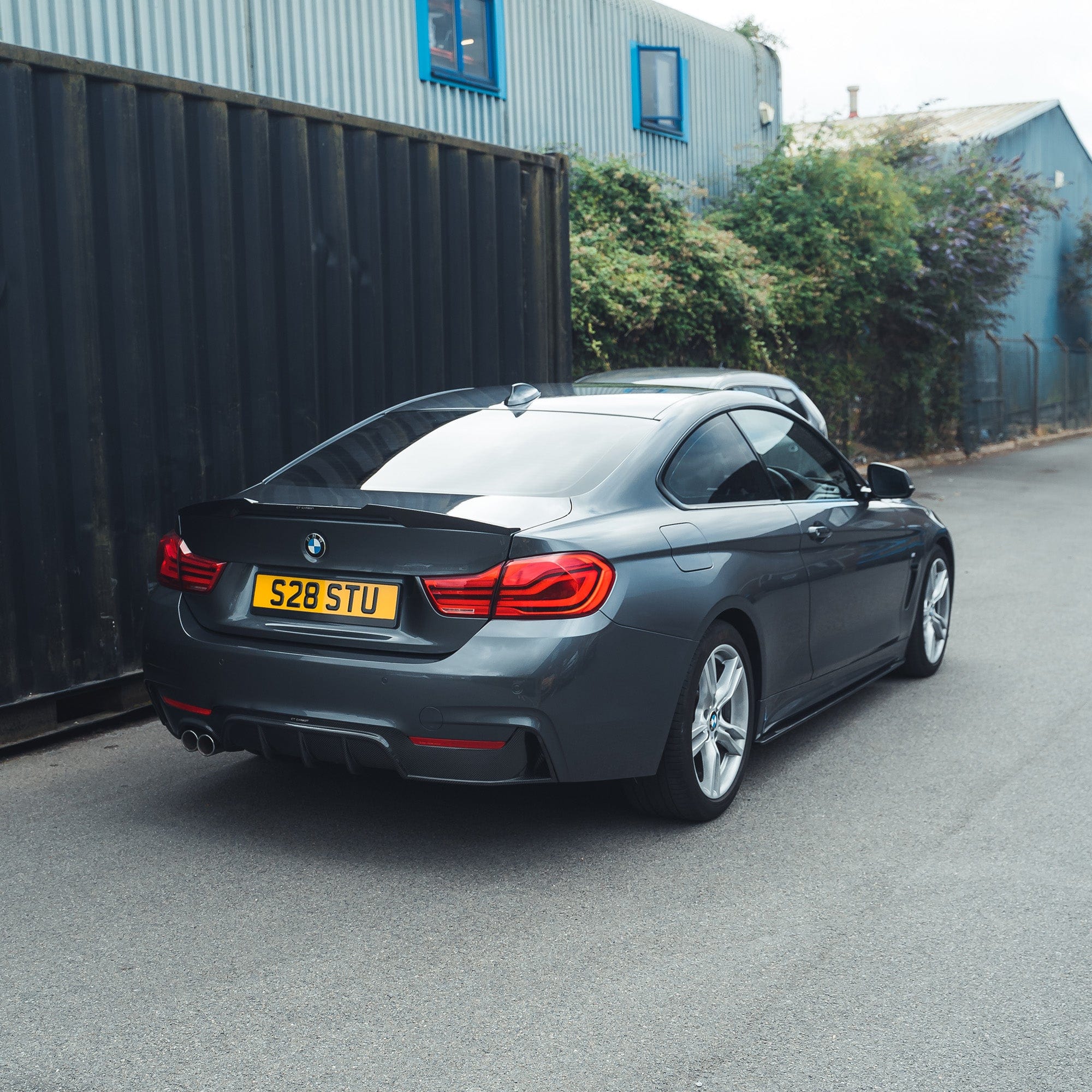 BMW F32 4 Series Coupe full carbon fiber kit with splitter and twin exhaust, designed by CT Carbon for a sporty, aerodynamic look.