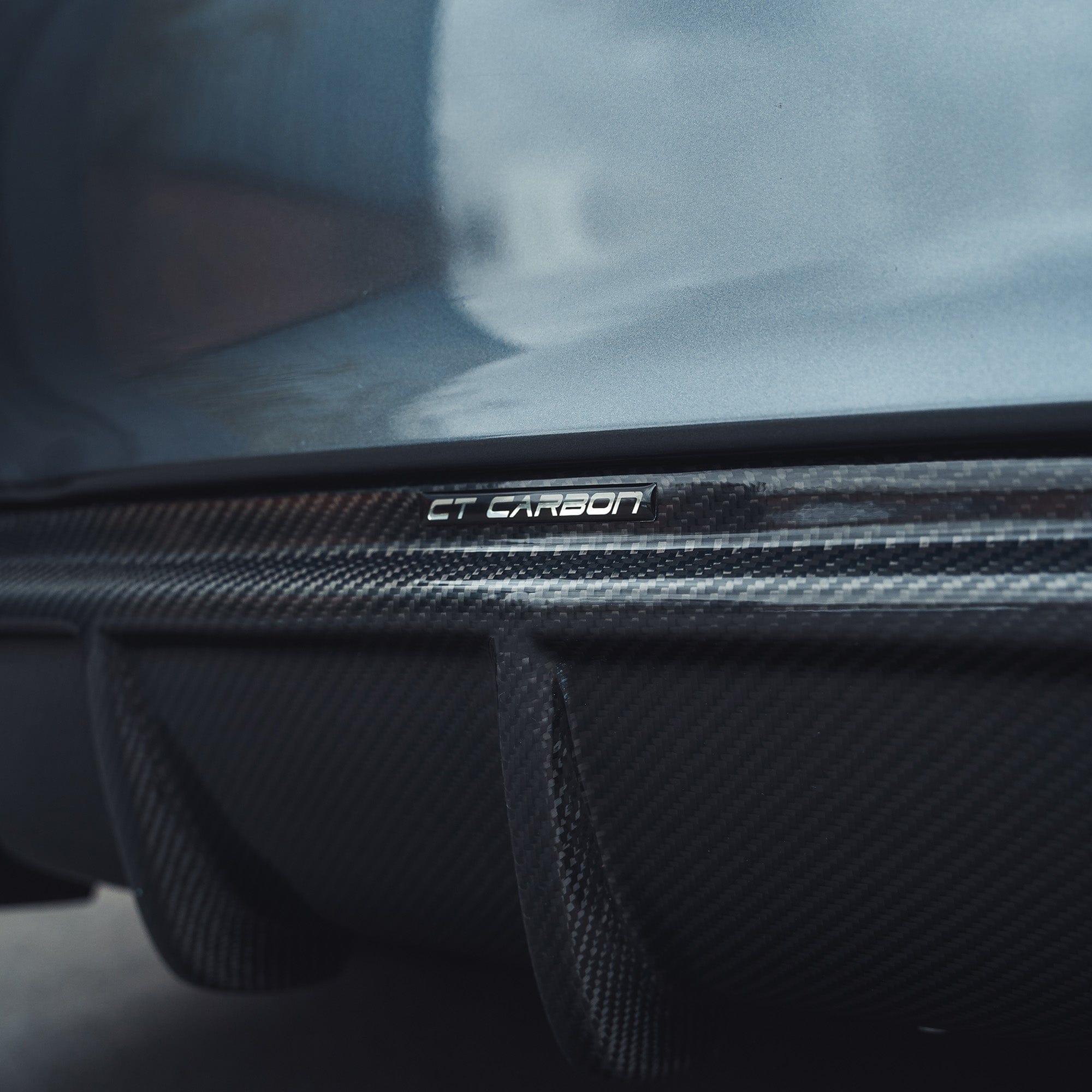 BMW F32 4 Series Coupe full carbon fibre kit with twin exhaust, showing splitter and sleek carbon fiber details by CT Carbon.