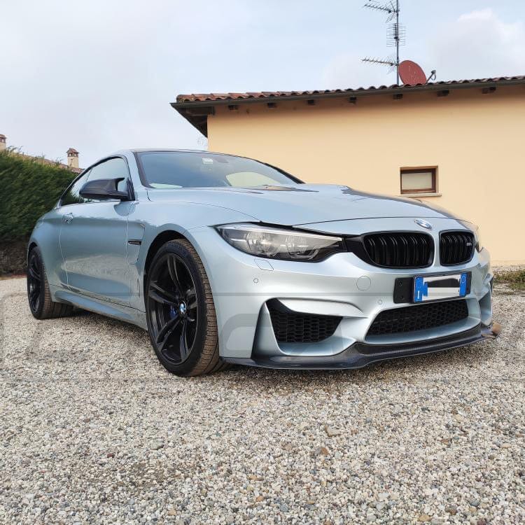 Full BMW M4 F83 convertible carbon fibre kit by CT Carbon, featuring splitters and aerodynamic components on a sleek car.