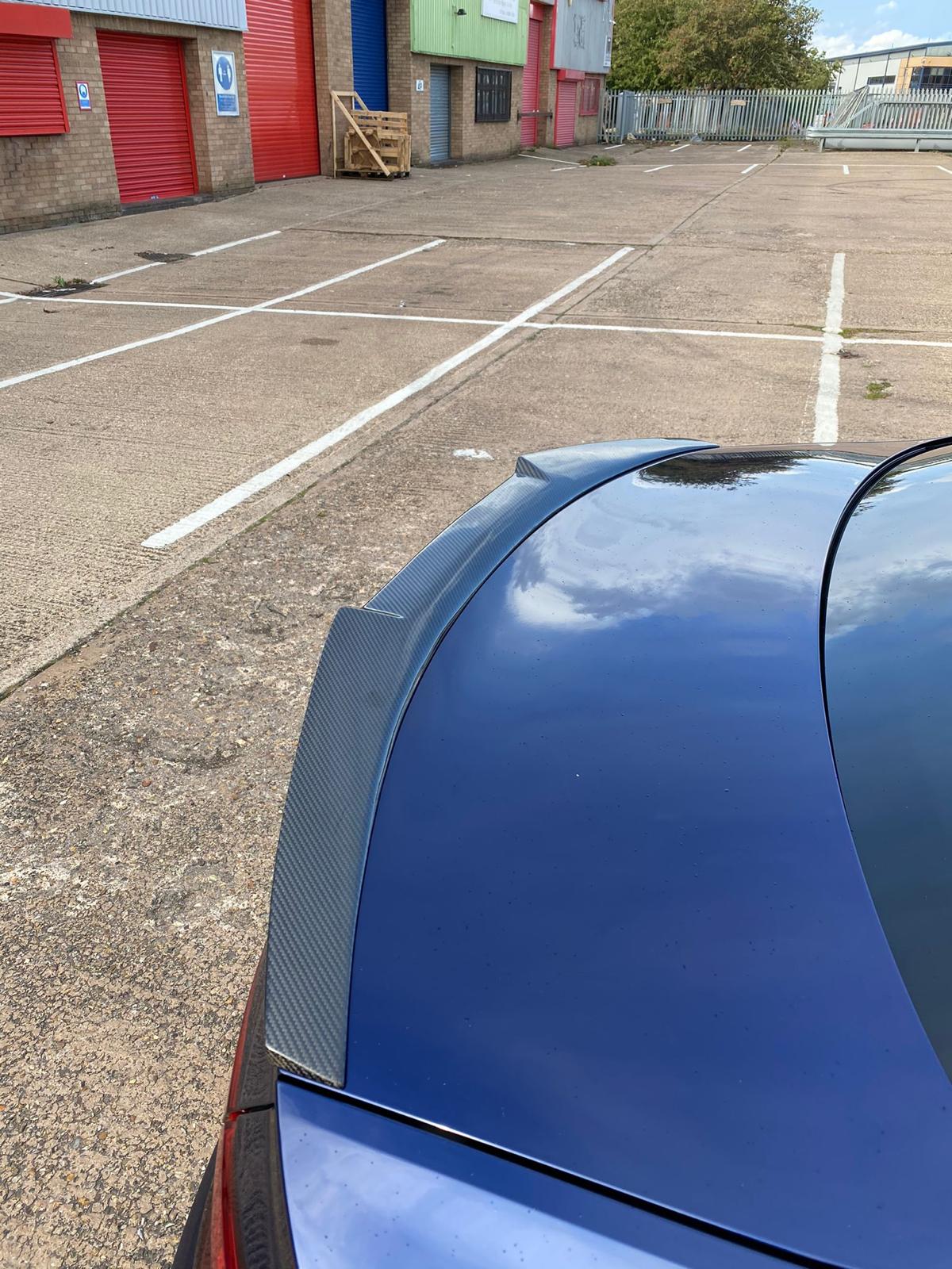 Carbon fiber spoiler for Audi A5/S5 B9 Coupe by CT Carbon, sleek V-style design enhancing sporty appearance and aerodynamics.