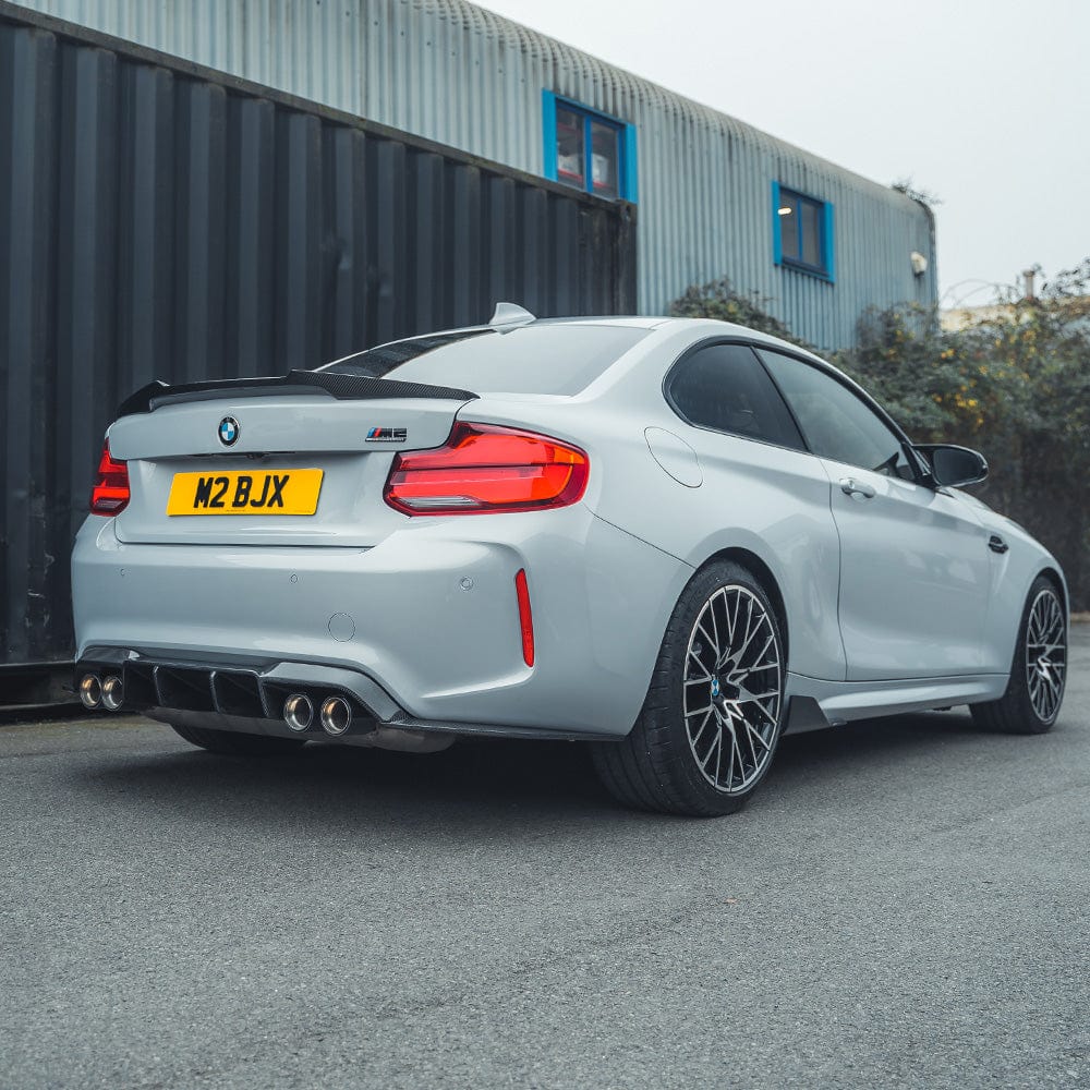 BMW M2 F87 and F22 carbon fibre spoiler by CT Carbon, M4 style, shown on the car's rear with sleek aerodynamic design.