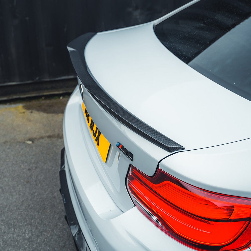 BMW M2 F87 M2C F22 carbon fibre spoiler by CT Carbon, M4 style, shown installed on the 2 Series coupe with sleek design.