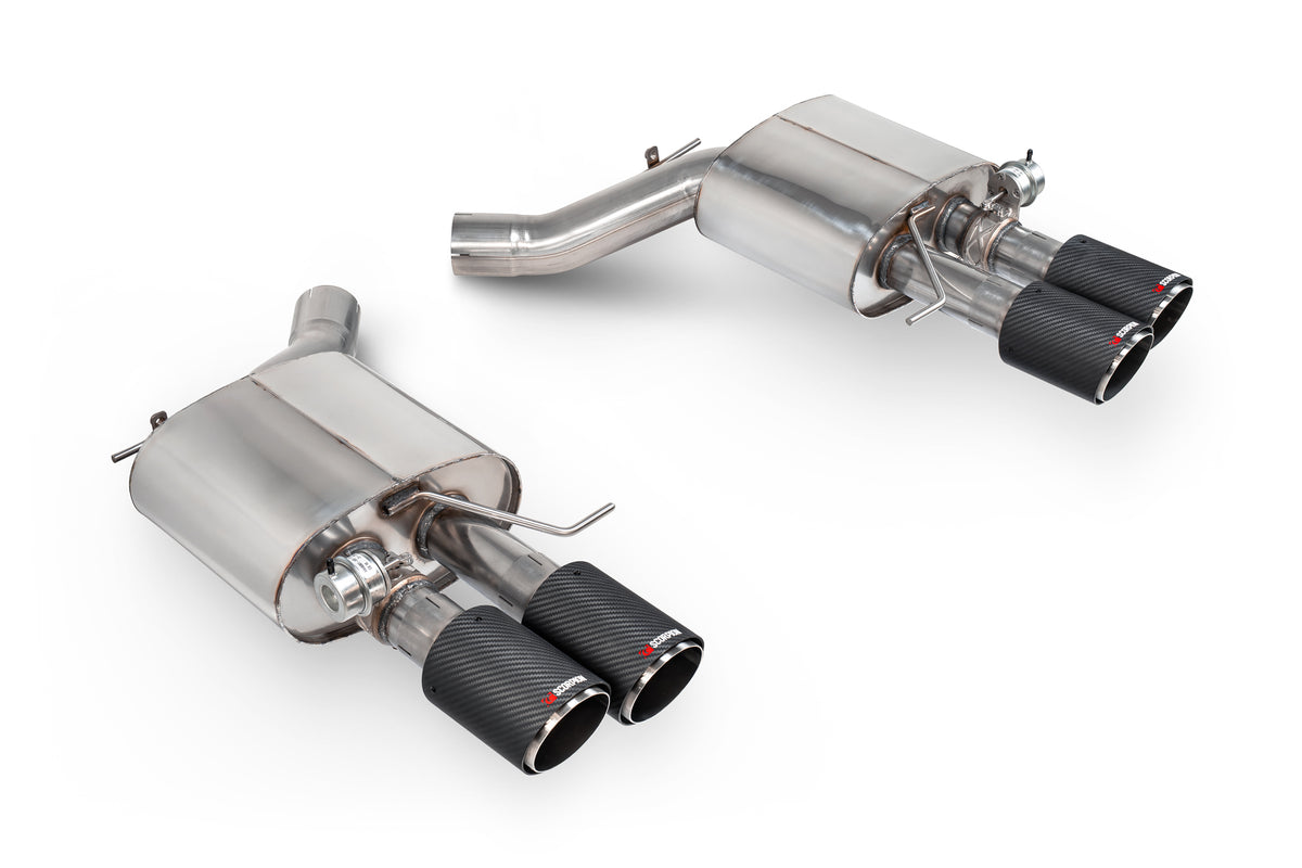 Scorpion BMW M5 F10 rear silencers showing polished metal exhaust tips and black muffler sections on a car's rear bumper.