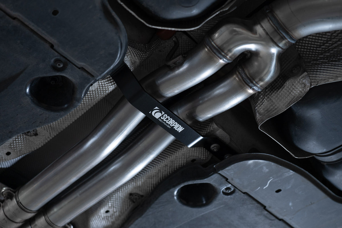 Scorpion Audi RSQ3 (F3) exhaust tunnel brace in black, mounted inside the vehicle’s engine bay showcasing durable metal construction.