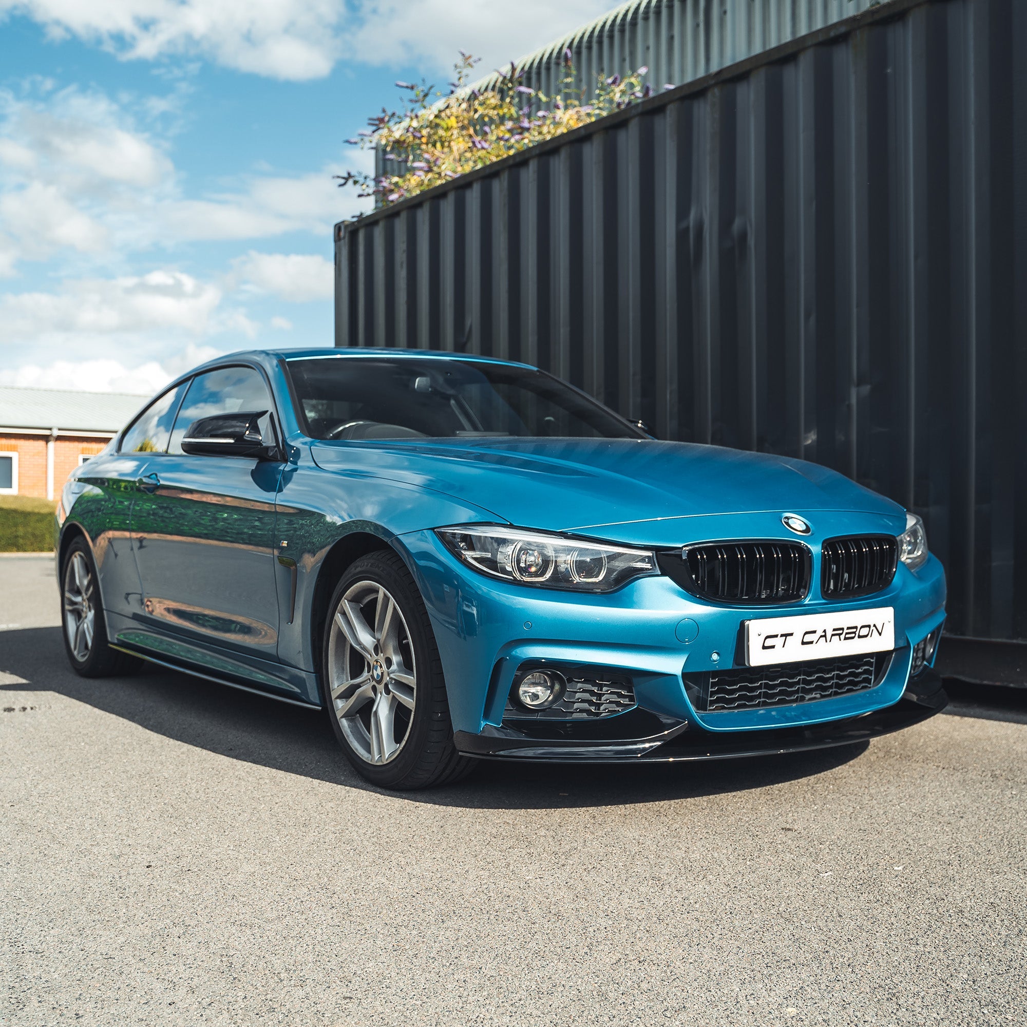 BMW 4 Series F32 2013-2020 gloss black full kit with twin exhaust by CT Carbon, featuring sleek aerodynamic design and high-quality finish.