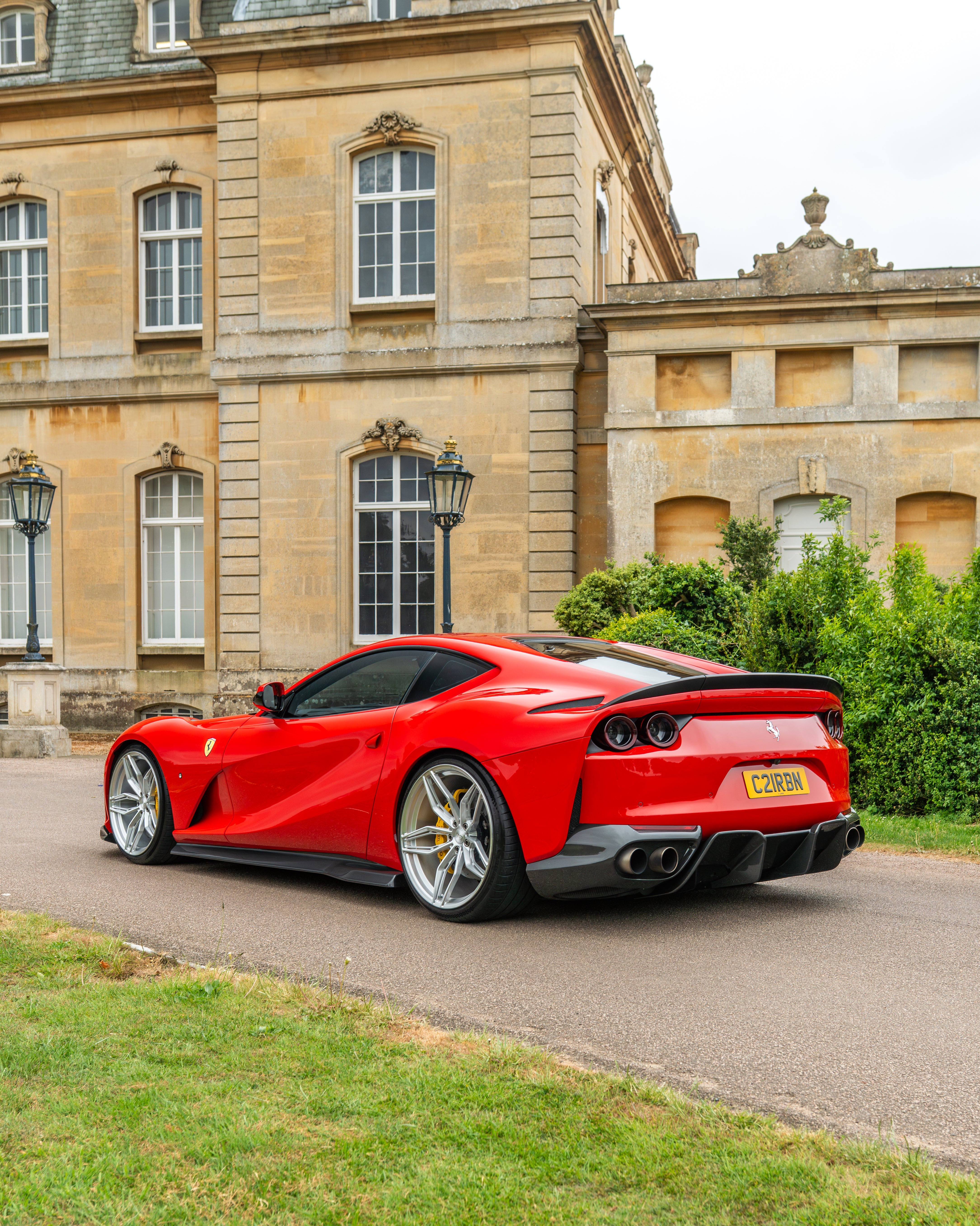 Carbon fiber spoiler for Ferrari 812 Superfast by CT Carbon, showing the sleek, aerodynamic design and textured finish.