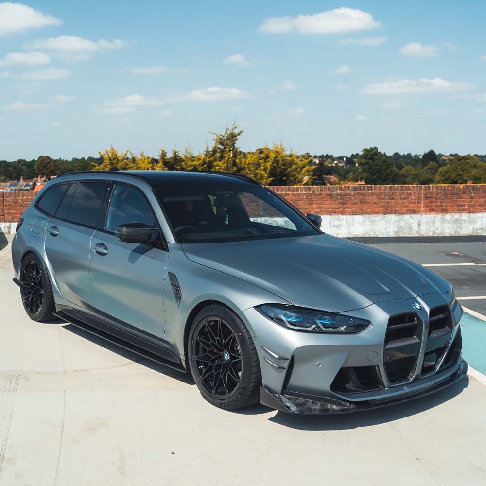 BMW G81 M3 Touring full carbon fiber kit by CT Carbon, showing detailed close-up of carbon fiber panels and aerodynamic design.