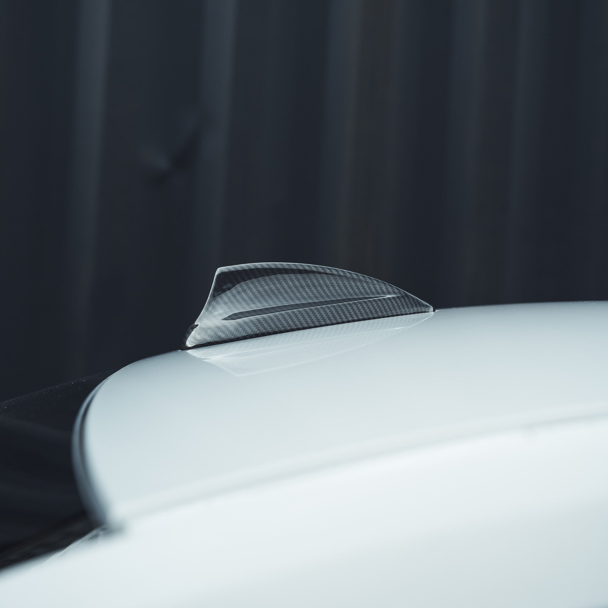BMW Fxx carbon fibre antenna cover by CT Carbon, showing sleek, lightweight accessory with a glossy carbon fibre finish.