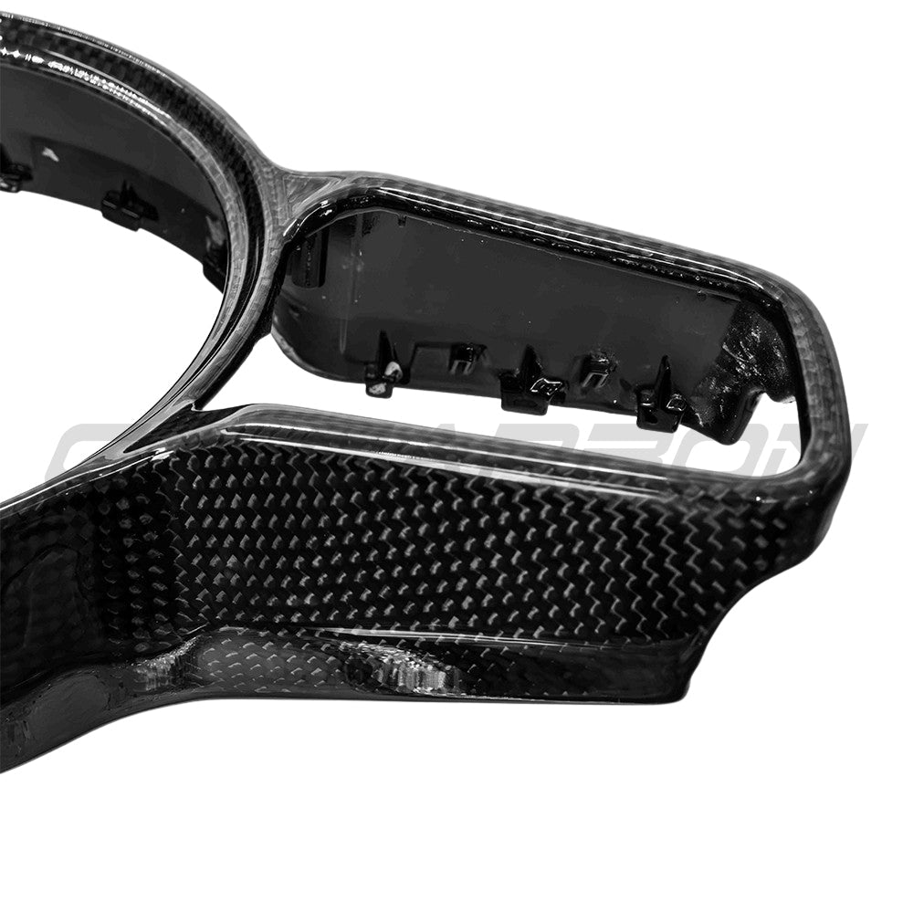 Carbon fiber steering wheel trim for Porsche 911, Cayman, Boxster, Cayenne, and Macan by CT Carbon, showcasing sleek, textured finish.